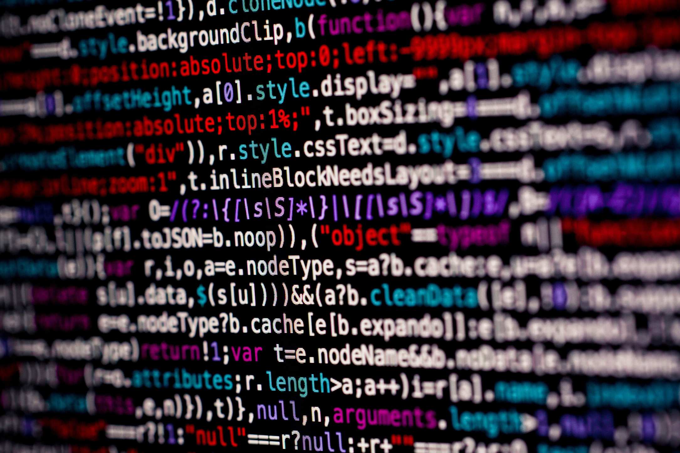 Developer workstation showing multicolored code on a monitor screen